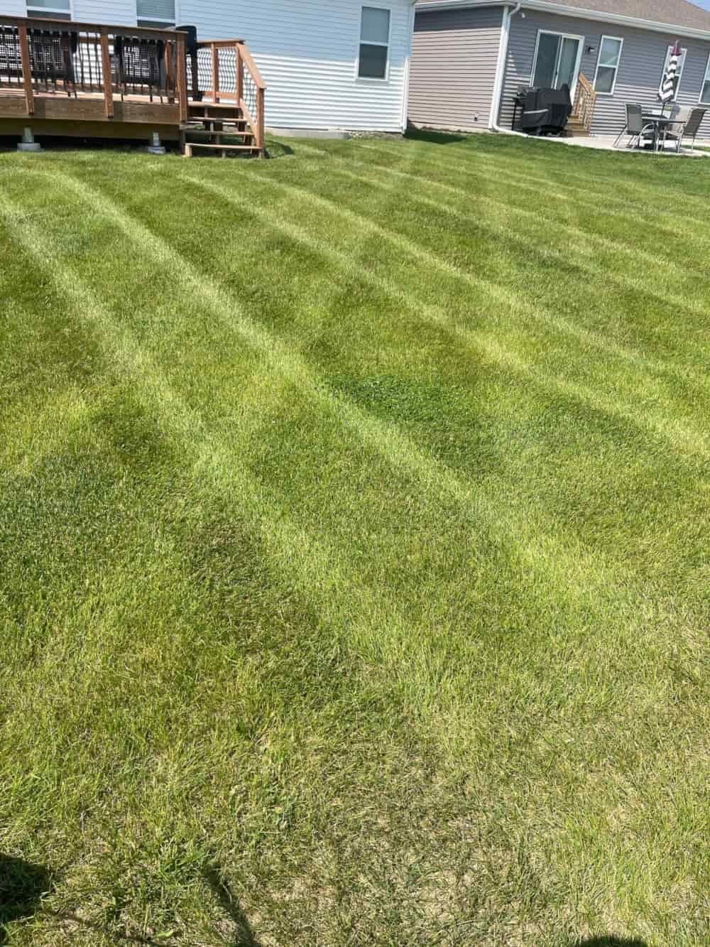 Lawn mowing crew maintaining property in Prairie Trail, Ankeny IA.