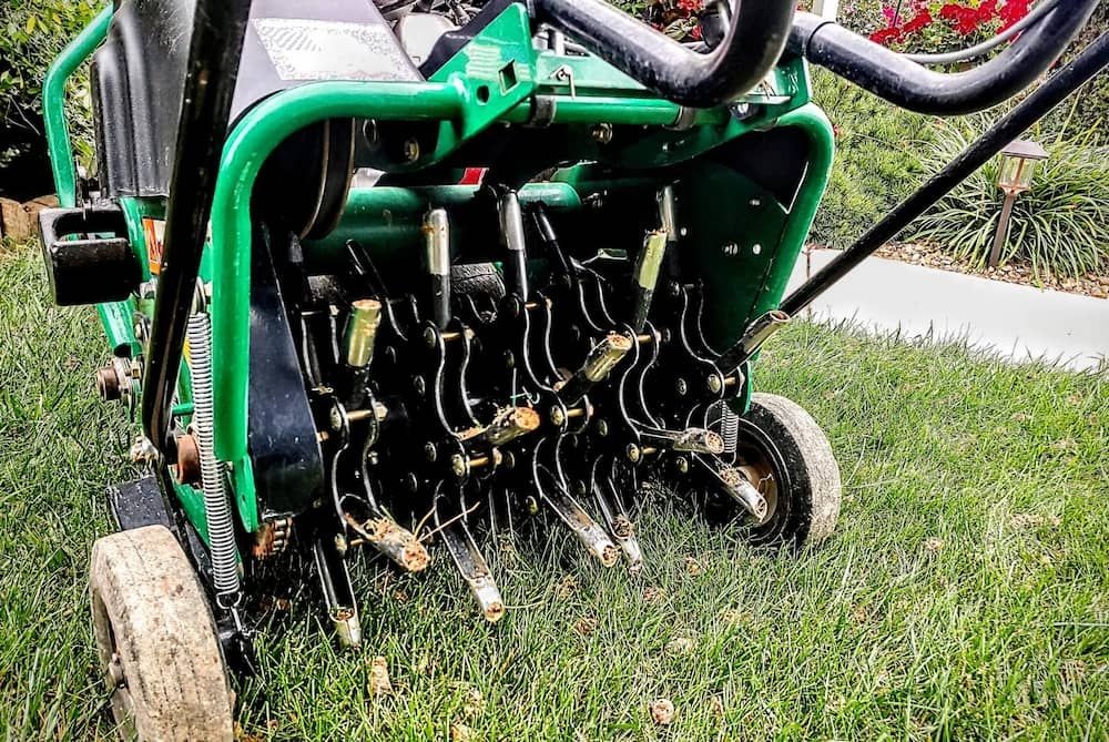 Core aeration equipment used on residential lawn in Ankeny